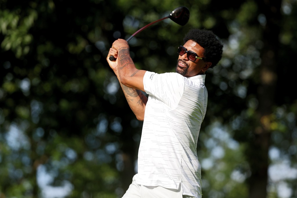 Jalen Rose hits a tee shot on the 18th hole during a celebrity shootout