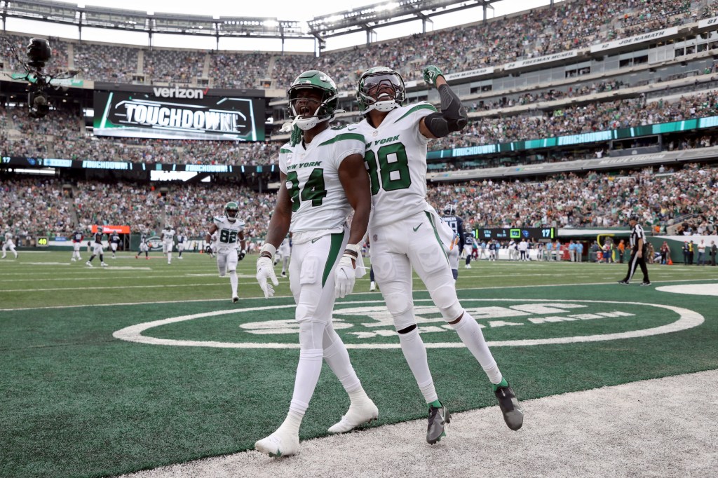 Corey Davis #84 of the New York Jets celebrates after a touchdown catch during the fourth quarter against the Tennessee Titans at MetLife Stadium on October 03, 2021. 