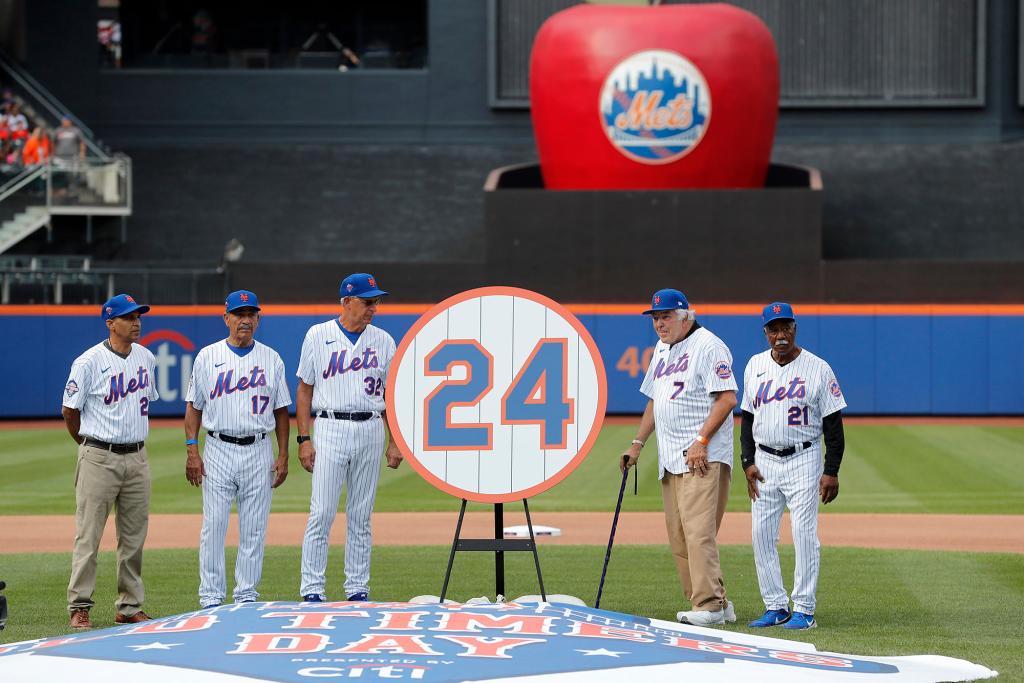 Michael Mays, son of baseball Hall of Famer Willie Mays, stands with former New York Mets Felix Millan #17, Jon Matlack #32, Ed Kranepool #7 and Cleon Jones #21 as the team retires May's #24 during Old Timers' Day festivities before a game against the Colorado Rockies at Citi Field on August 27, 2022.