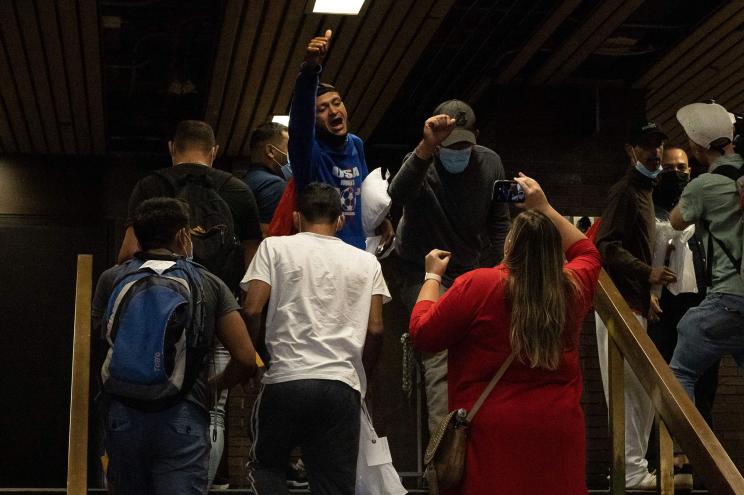 A group of migrants reacts after arriving at Port Authority Bus Terminal from Texas on August 10.