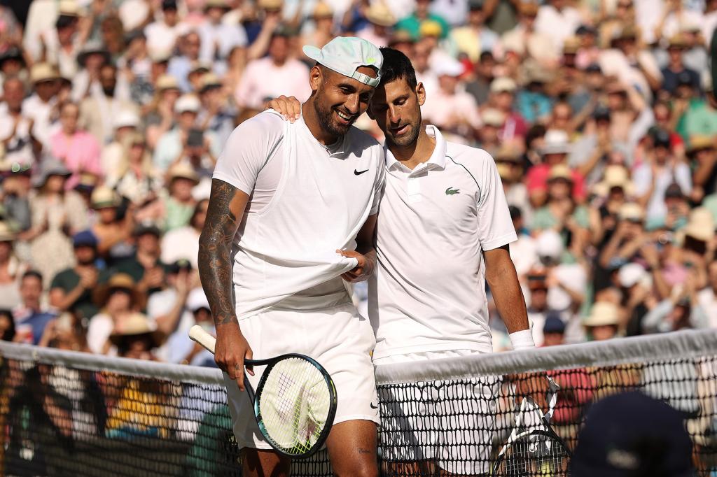 Novak Djokovic of Serbia (L) and runner up Nick Kyrgios of Australia interact by the net following their Men's Singles Final match day fourteen of The Championships Wimbledon 2022.