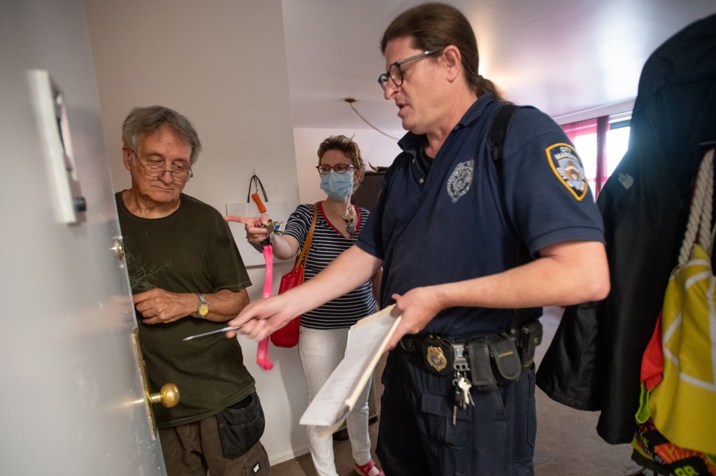 Kevin and Heidi Russell and City Marshal Robert Renzuli discuss the new lock being installed.