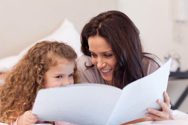 Mother and daughter reading a book together