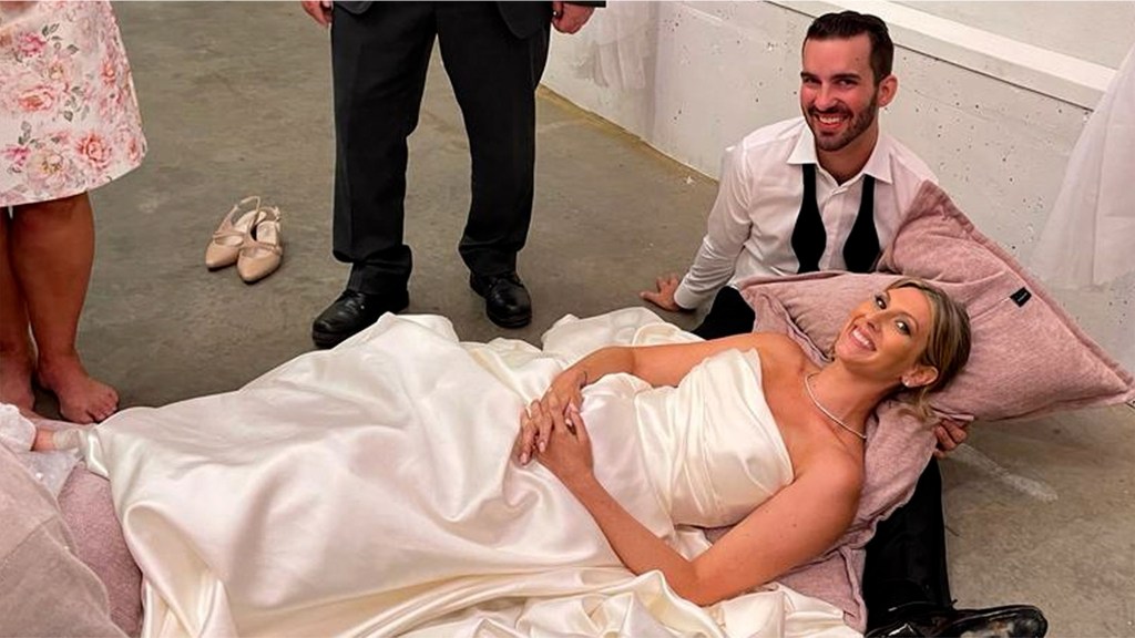 Bride laying on the dance floor with a broken ankle