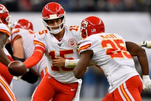 Chiefs quarterback Patrick Mahomes (#15) hands off the ball to running back LeSean McCoy in Nov. 2019.