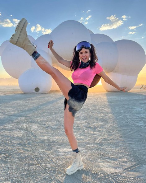 This girl is on fire: Nina Dobrev feels the heat at Burning Man and isn’t afraid to show it.