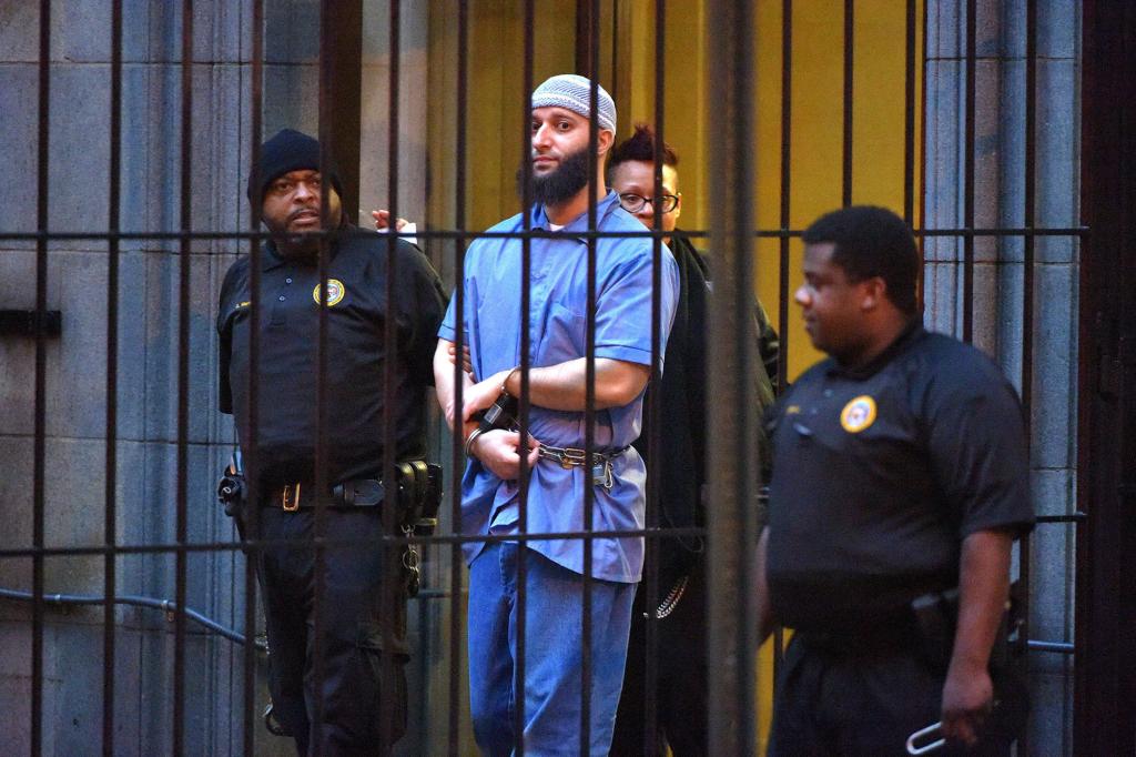 Officials escort "Serial" podcast subject Adnan Syed from the courthouse on Feb. 3, 2016, following the completion of the first day of hearings for a retrial in Baltimore.