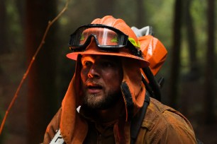 Max Thieriot as Bode Donovan. He's wearing firefighting equipment and is fighting a wildfire.