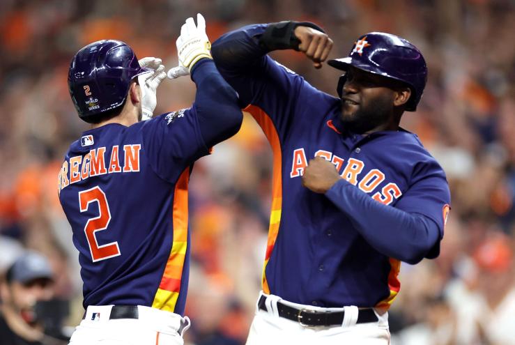 Alex Bregman (left) is congratulated by Yordan Alvarez after blasting a two-run homer in the fifth inning of the Astros' 5-2 win over the Phillies in Game 2 of the World Series.