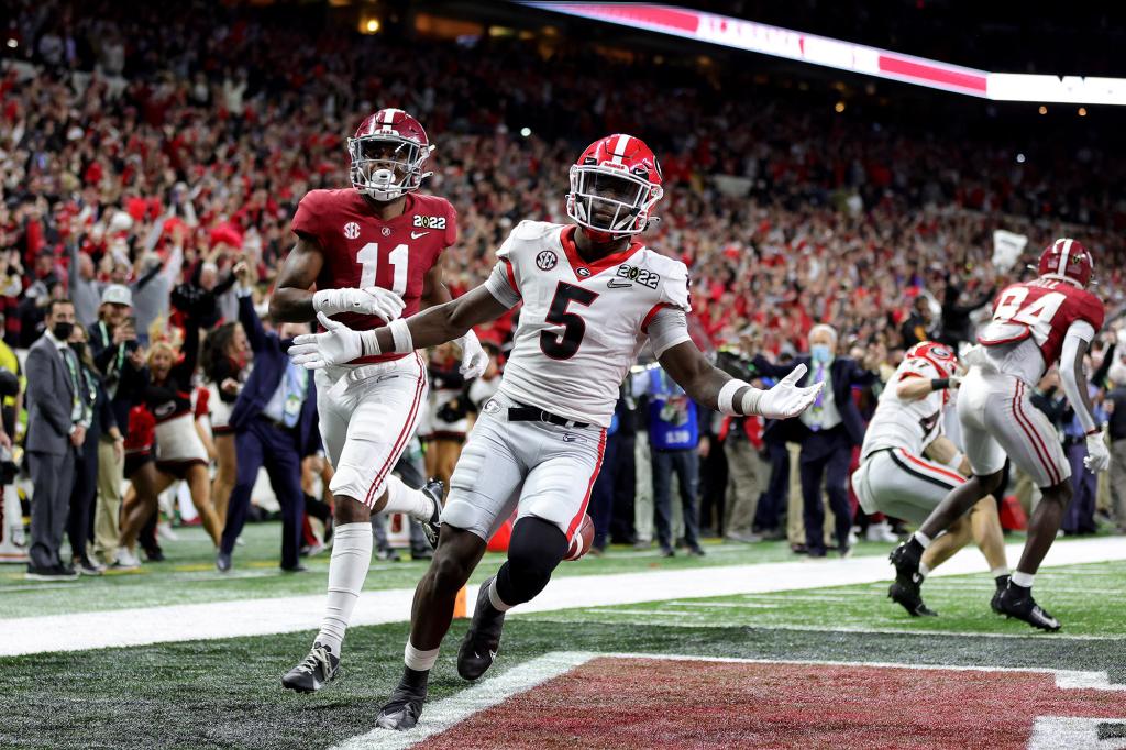 Kelee Ringo #5 of the Georgia Bulldogs carries the ball into the endzone after getting an interception in the fourth quarter of the game against the Alabama Crimson Tide during the 2022 CFP National Championship Game at Lucas Oil Stadium on January 10, 2022 in Indianapolis, Indiana.