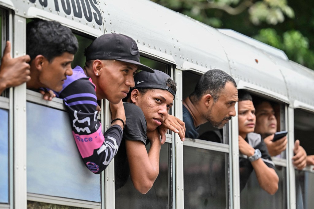 Venezuelan migrants arrive at an improvised shelter in Panama City on October 23, 2022.