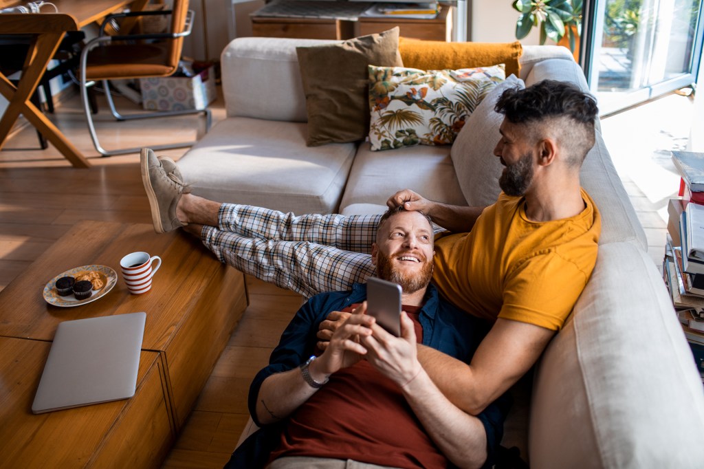 Male couple using a phone.