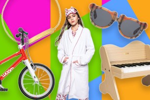 A girl in a bathrobe wearing sunglasses and with a bicycle