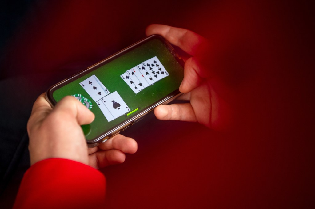  An online game is played on a smartphone. With the new State Treaty on Gambling, which comes into force on July 1, previously prohibited virtual slot machine games on the Internet and online casinos with poker or roulette will be allowed. 