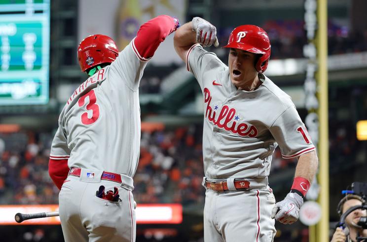Bryce Harper #3 and J.T. Realmuto #10 of the Philadelphia Phillies celebrate after Realmuto hit a home run in the 10th inning against the Houston Astros in Game One of the 2022 World Series at Minute Maid Park on October 28, 2022 in Houston, Texas.