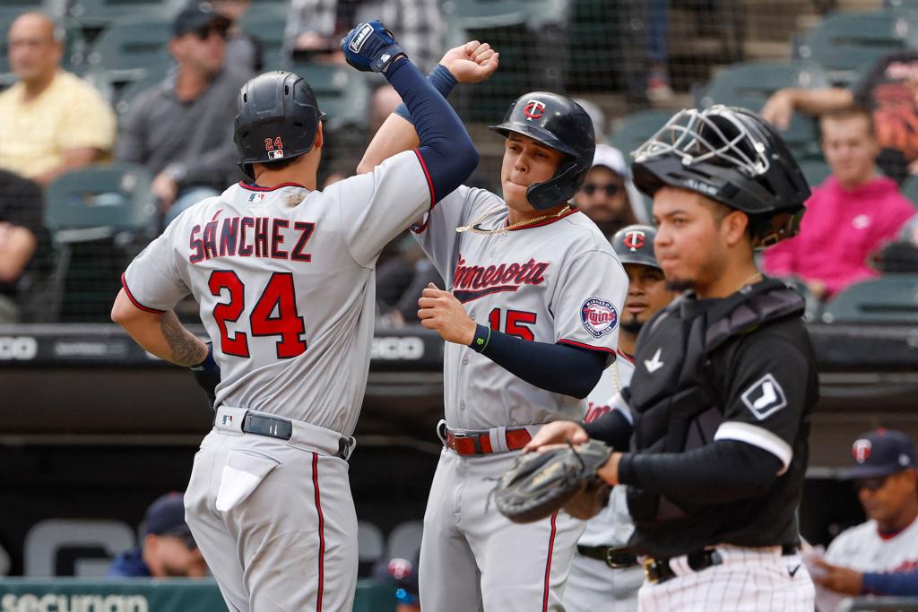 Minnesota Twins catcher Gary Sanchez (24) celebrates with third baseman Gio Urshela (15) after hitting a three-run home run against the Chicago White Sox on Oct. 5, 2022.