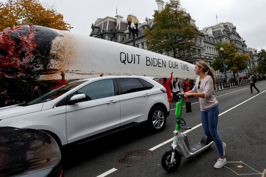 The protest featured a large inflatable joint that said “Stop Biden Our Time.”
