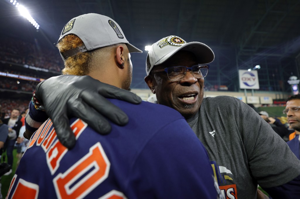 Dusty Baker celebrates with Martin Maldonado after winning his first World Series as a manager.