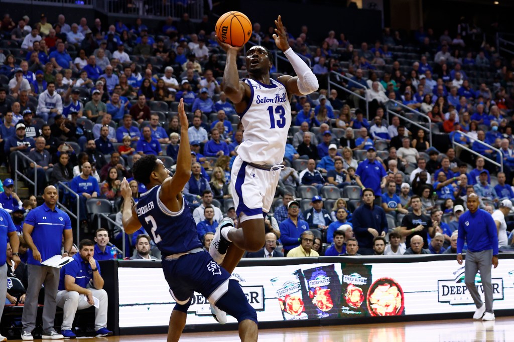 KC Ndefo (13) of Seton Hall attempts a shot as Jayden Saddler of Saint Peter's defends during the second half Saturday in Newark.