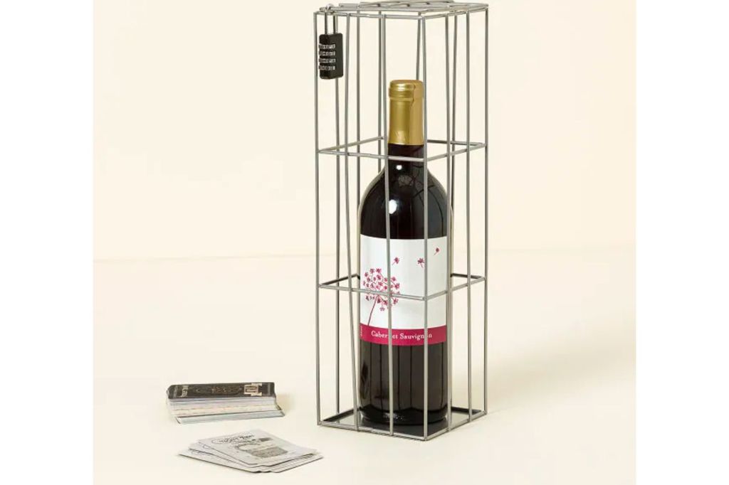 Bottle of wine in a cage with cards on the outside as part of an escape room at home game.