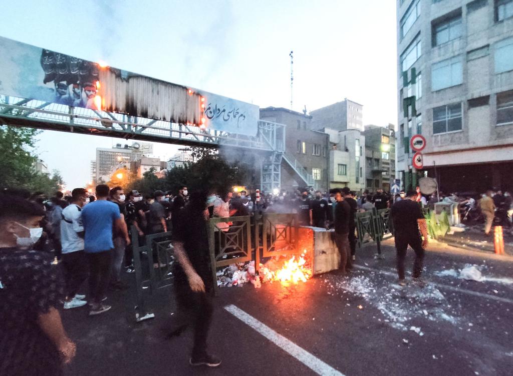 Protesters burn a trash can during a rally in Tehran for Amini in late September, just days after she died.