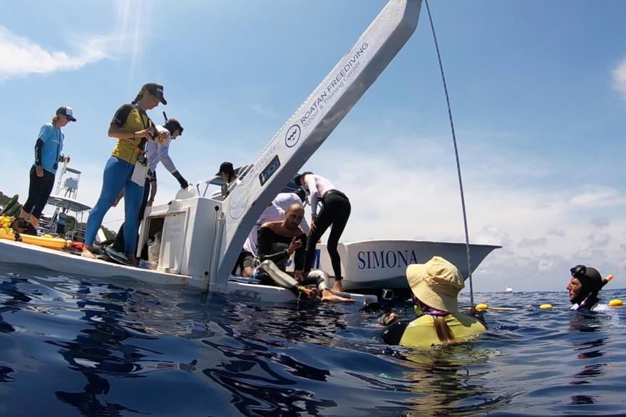 People helping Miguel after his free dive.