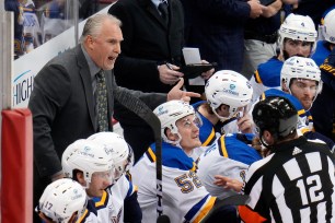 St. Louis Blues head coach Craig Berube, left, talks with official