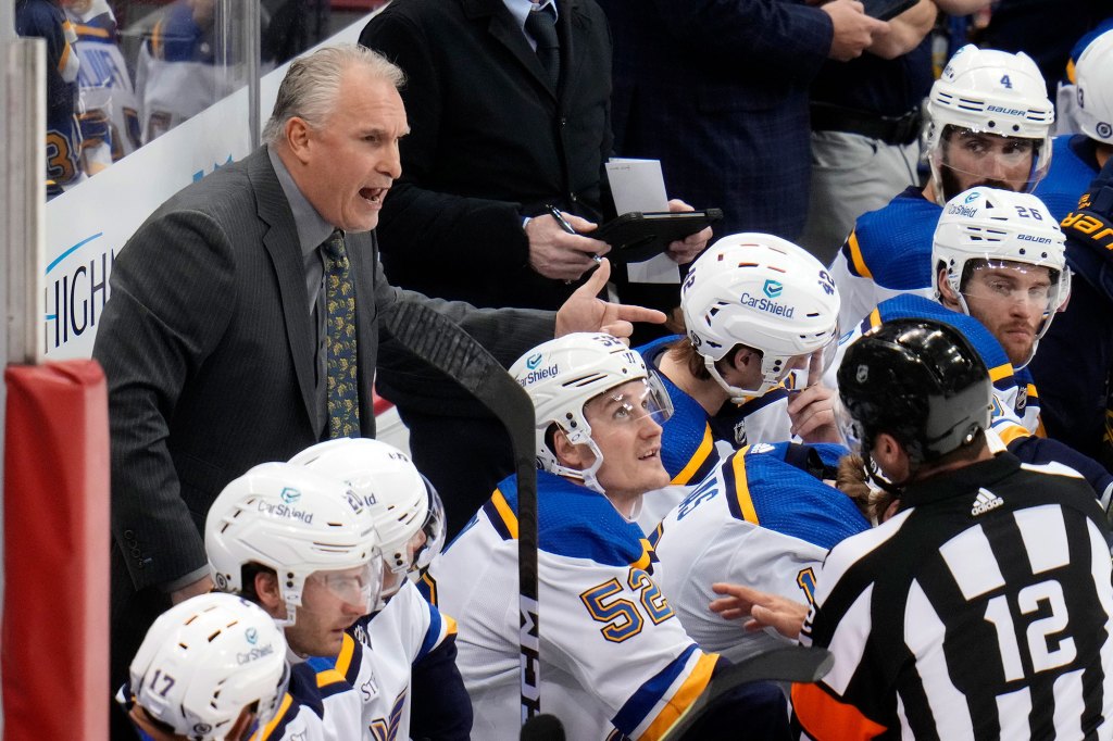 St. Louis Blues head coach Craig Berube, left, talks with official 