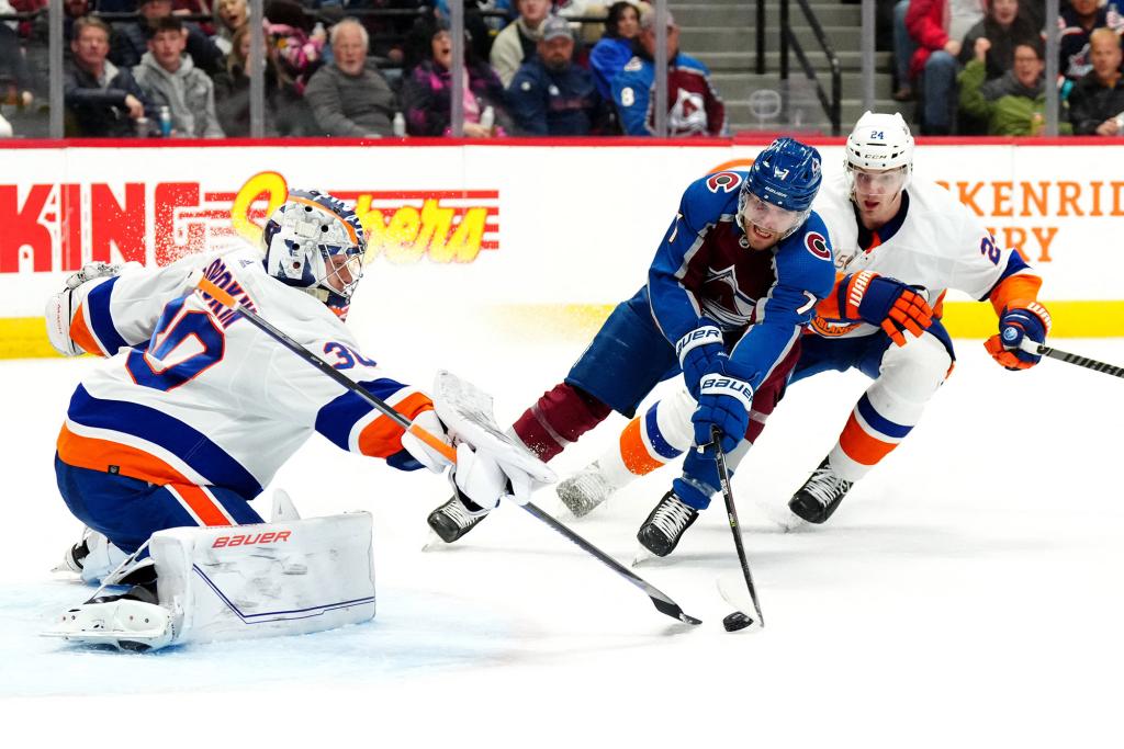 New York Islanders goaltender Ilya Sorokin (30) and defenseman Scott Mayfield (24) defend on Colorado Avalanche defenseman Devon Toews (7) in the second period at Ball Arena.