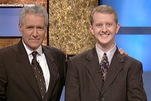 Former "Jeopardy!" host Alex Trebek poses with then-contestant Ken Jennings after his earnings from his record-breaking streak surpassed $1 million on July 14, 2004.