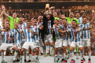 Lionel Messi lifts the World Cup trophy as he and Argentina celebrate their win on Dec. 18, 2022.