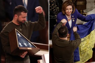 President of Ukraine Volodymyr Zelensky gives a Ukrainian flag to U.S. Speaker of the House Nancy Pelosi and Vice President Kamala Harris on Dec. 21, 2022 in Washington, DC.