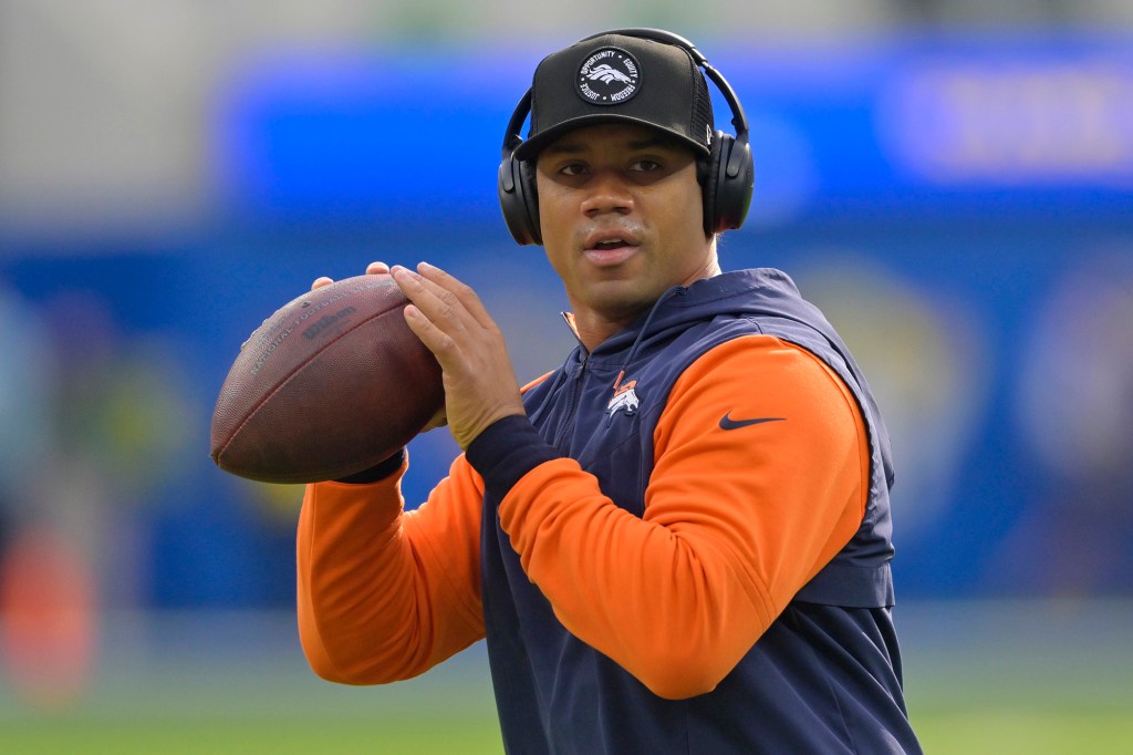 Broncos quarterback Russell Wilson warms up before a game against the Rams on Dec. 25, 2022.