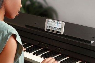 Promotional image for Skoove featuring a student practicing on a keyboard.