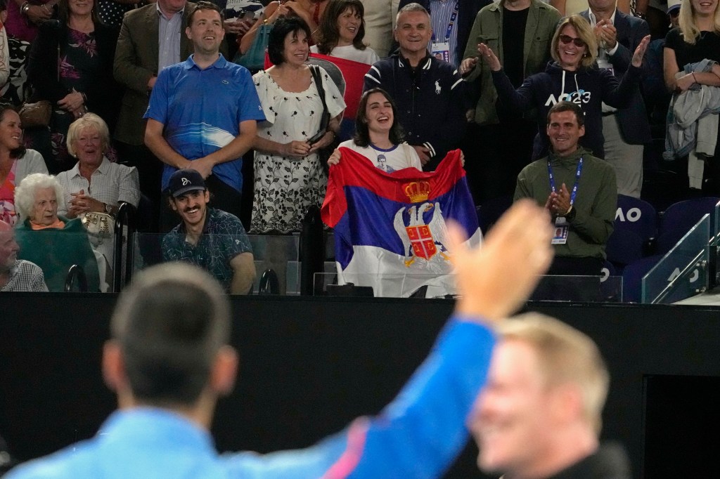 Djokovic waves to his parents following his quarterfinal win on Wednesday in Melbourne.