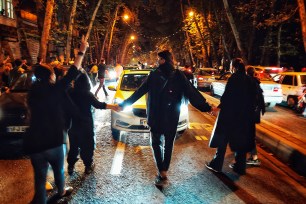 People protest the death of 22-year-old woman Mahsa Amini who was detained by the morality police, in Tehran, Oct. 1, 2022.