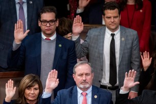 Santos, left, is sworn-in beside Rep. Matt Gaetz on Jan. 7, 2023.