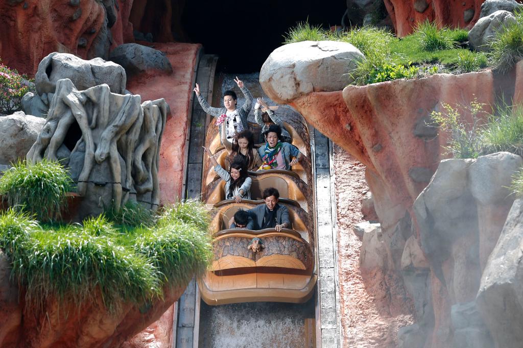 Visitors ride down a waterway on the Splash Mountain attraction at Tokyo Disneyland, operated by Oriental Land Co., in Urayasu City