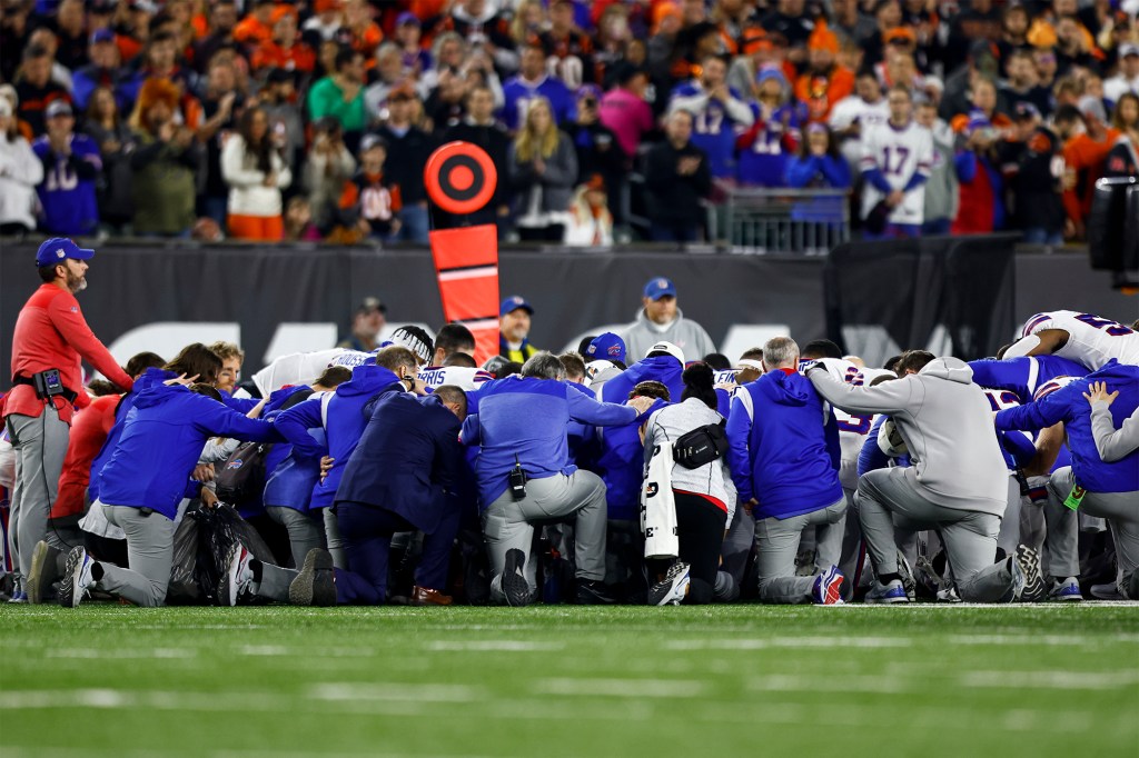 Buffalo Bills players and personnel kneel in solidarity for Damar Hamlin on Jan. 2, 2023.