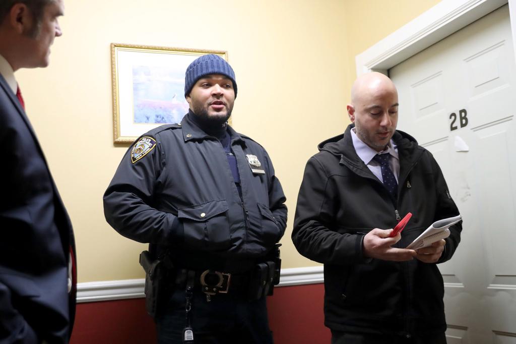 Officers at the apartment door inside 1447 Doris Street in the Bronx.