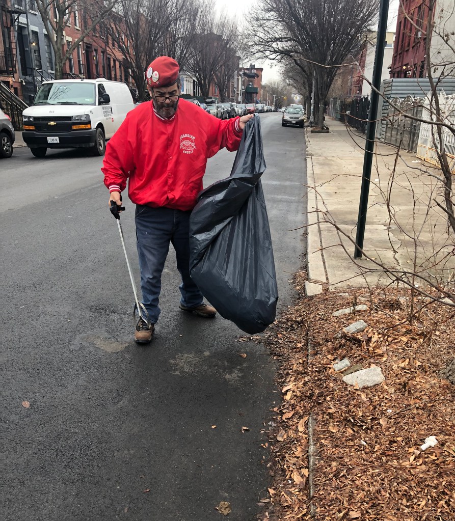 Picture of Guardian Angel picking up trash near Eric Adams personal residence on Lafayette Avenue.