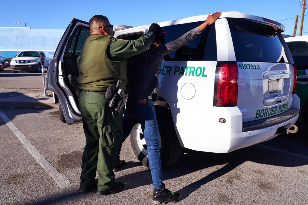 A migrant is taken into custody by U.S. Customs and Border Protection officers from Sacred Heart Church.