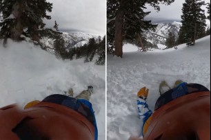 Helmet-cam footage of snowboarder sliding down mountain during avalanche