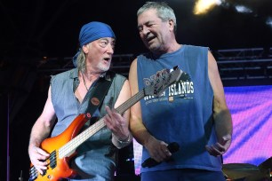 Bassist Roger Glover (L) and singer Ian Gillan of Deep Purple perform together onstage.