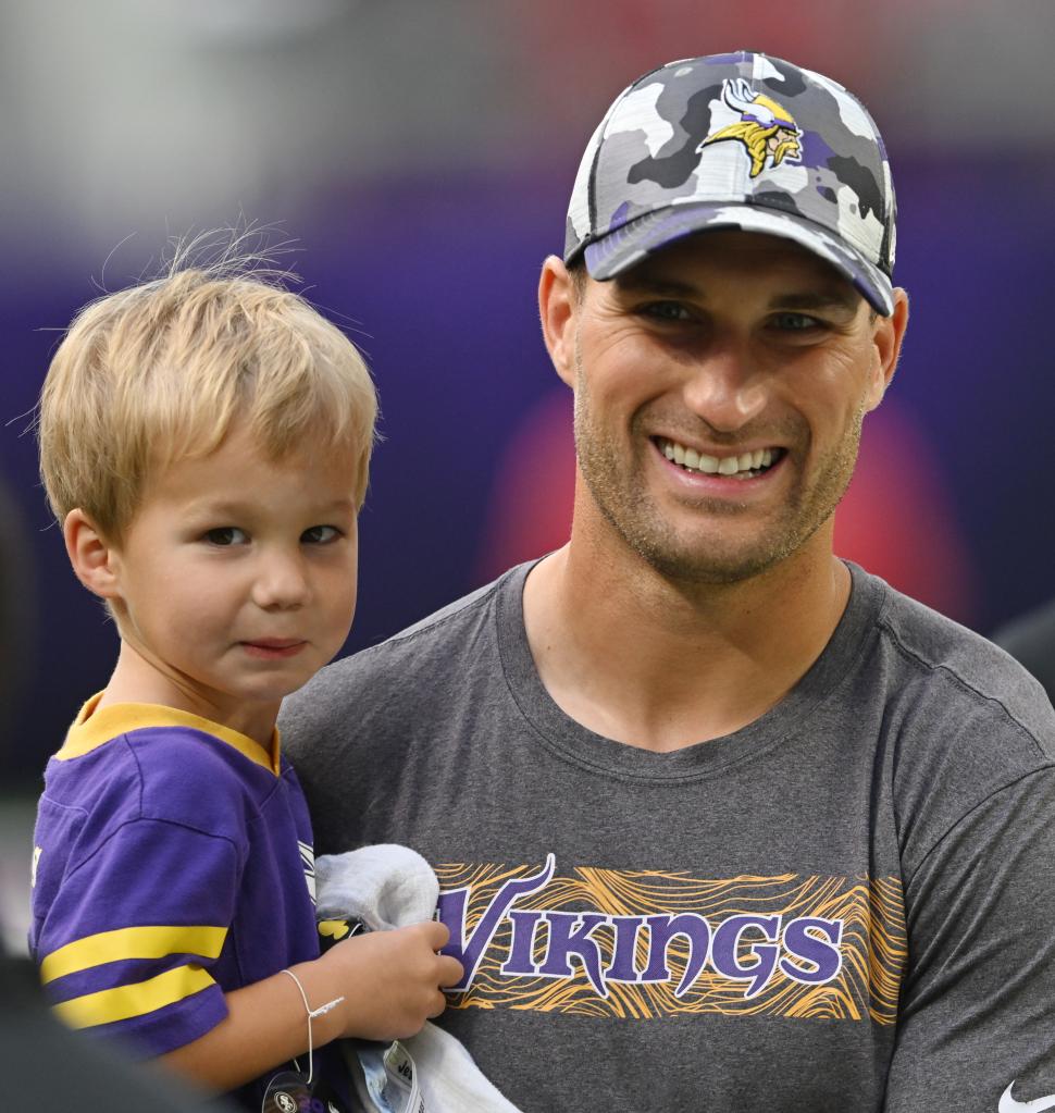 Kirk Cousins carries his son, Turner, before the start of an NFL preseason football game against the San Francisco 49ers.