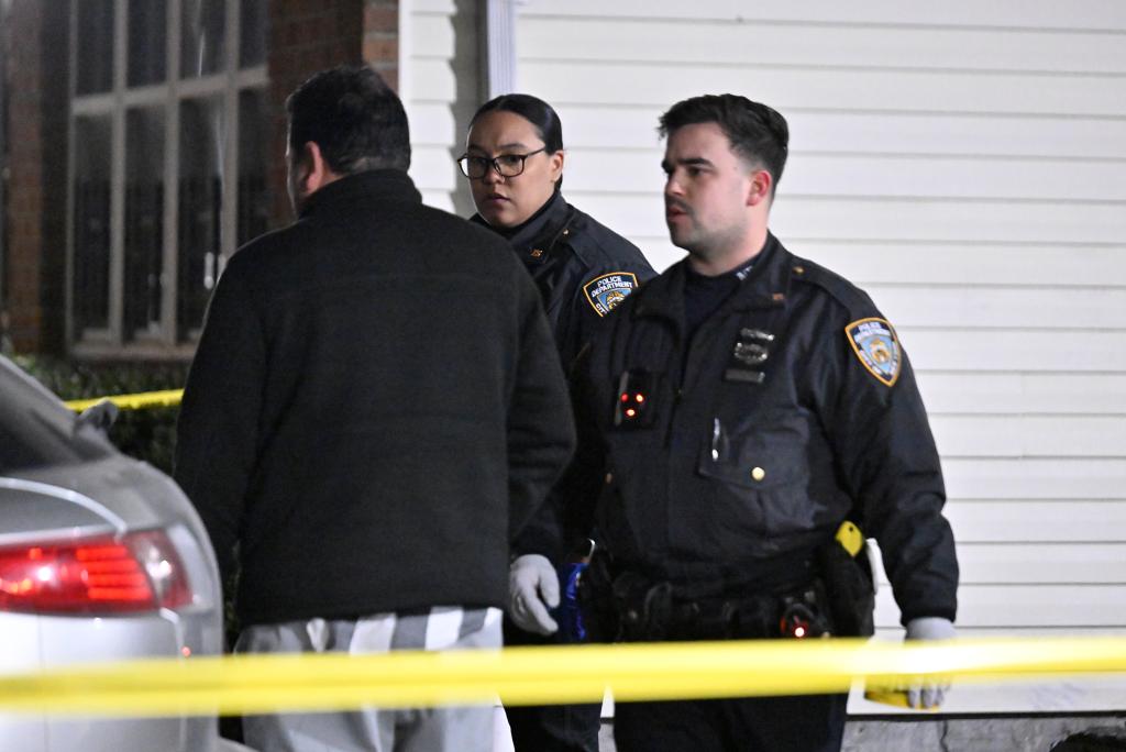 Three cops are seen at the scene of the shooting at 472 Ruby Street.