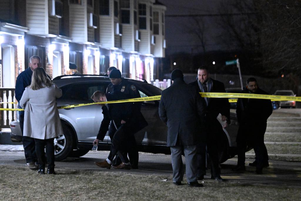 Investigators respond to the scene at 472 Ruby Street where an off-duty cop was shot during a botched robbery.
