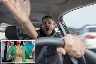 Wide angle look inside in the car of actually driving young male with hands in foreground.