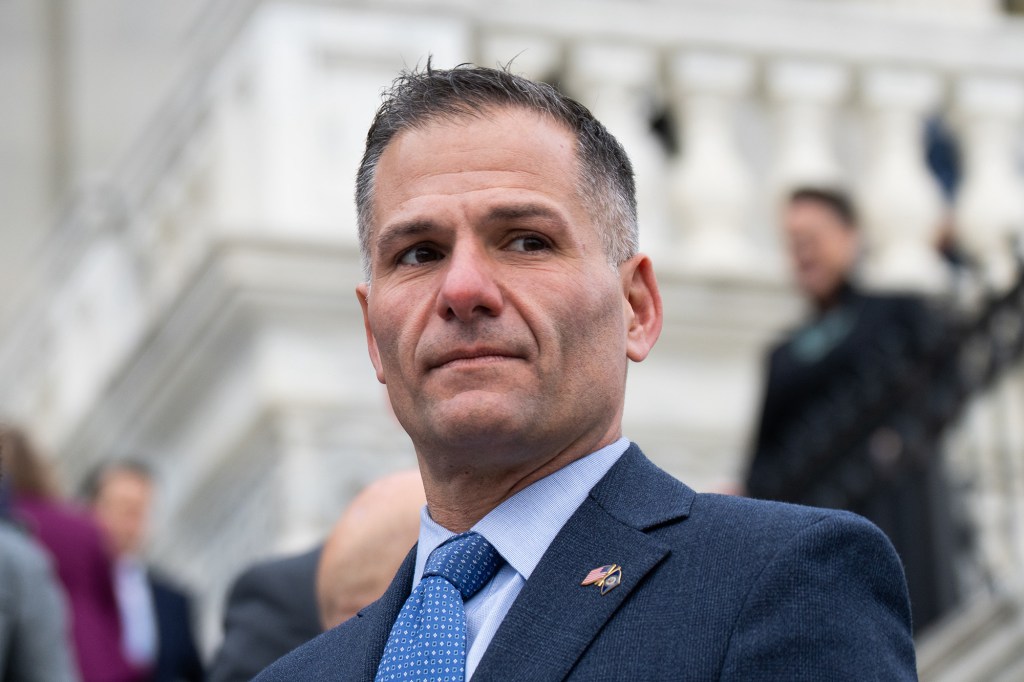 Congressman Marc Molinaro in a suit with a serious expression