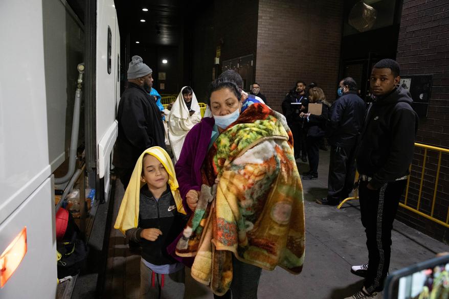Migrants are seen arriving at the Port Authority Bus Terminal in Manhattan, Monday, Dec. 19, 2022.